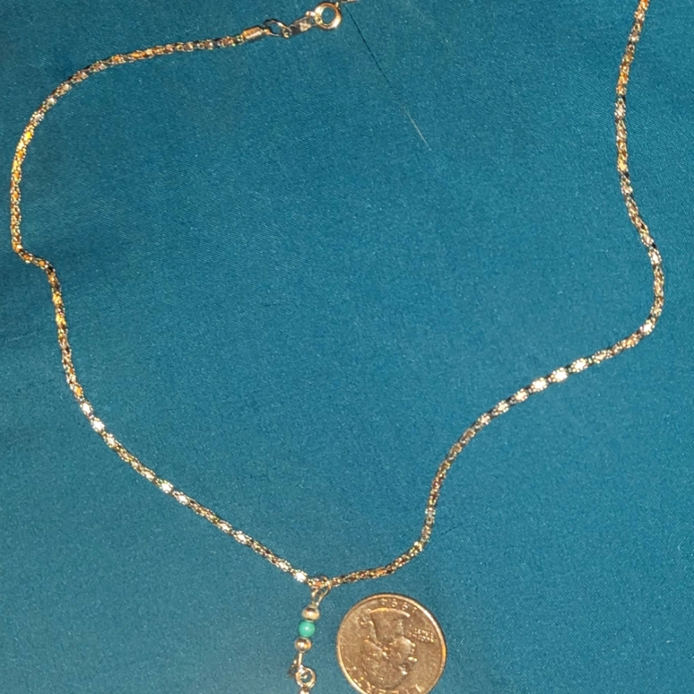 Necklace. Silver color and turquoise like bead.
